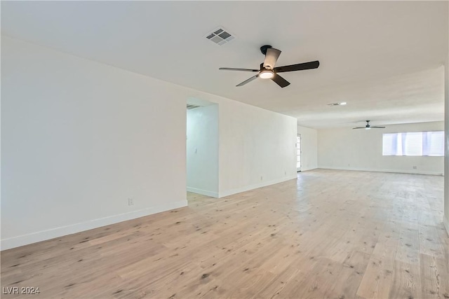 unfurnished room with ceiling fan and light wood-type flooring