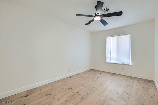 spare room featuring light hardwood / wood-style floors and ceiling fan