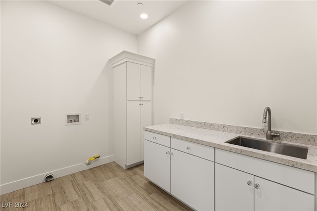 laundry area featuring cabinets, sink, hookup for a washing machine, light hardwood / wood-style flooring, and hookup for an electric dryer