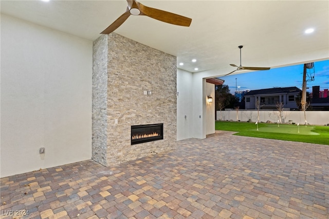 unfurnished living room with an outdoor stone fireplace