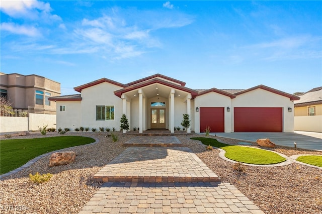 view of front of home with french doors and a garage