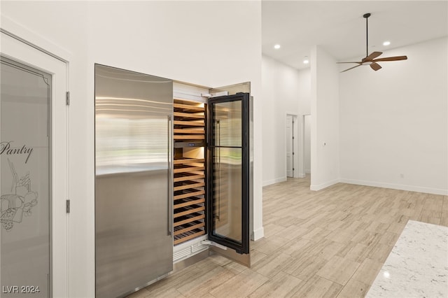 interior space with light stone countertops, ceiling fan, and light hardwood / wood-style floors