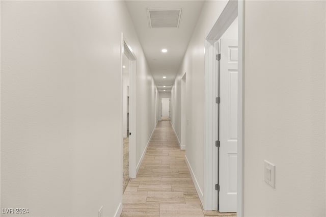 corridor with light hardwood / wood-style flooring