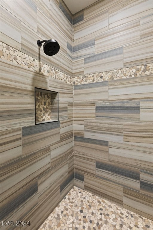 bathroom with tiled shower