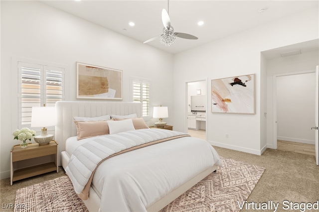 carpeted bedroom featuring ceiling fan and ensuite bathroom