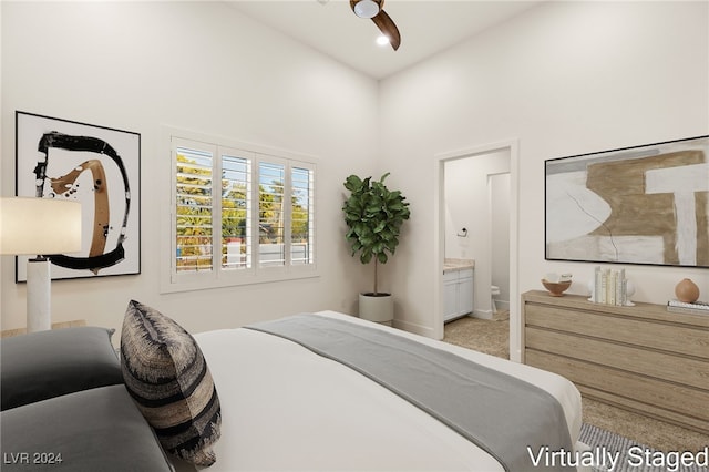 bedroom featuring carpet, ceiling fan, a towering ceiling, and connected bathroom