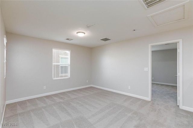 spare room featuring light colored carpet