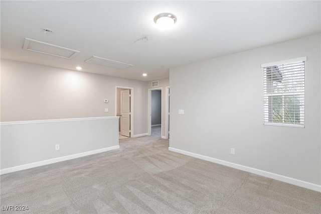 spare room featuring light colored carpet