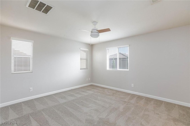 carpeted empty room featuring ceiling fan