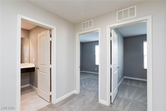 hallway with light colored carpet