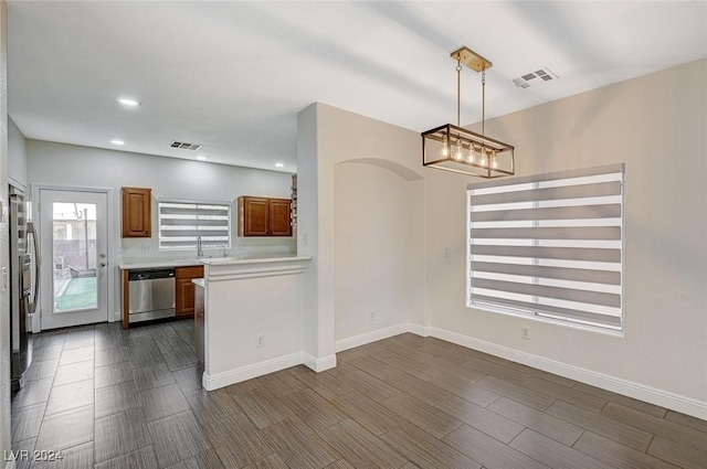 kitchen with hanging light fixtures and appliances with stainless steel finishes