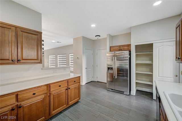 kitchen featuring stainless steel fridge with ice dispenser