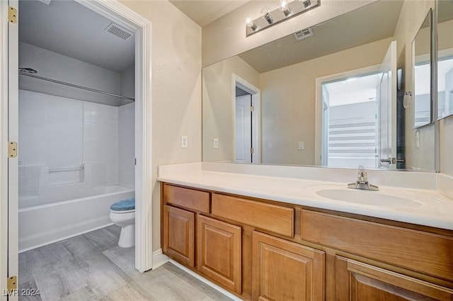 full bathroom featuring bathtub / shower combination, hardwood / wood-style floors, vanity, and toilet