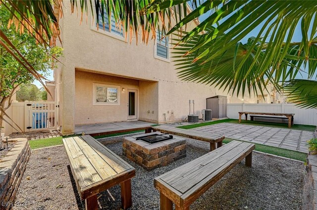 exterior space with a fire pit, a patio area, and central air condition unit