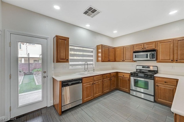 kitchen with sink, a healthy amount of sunlight, and appliances with stainless steel finishes