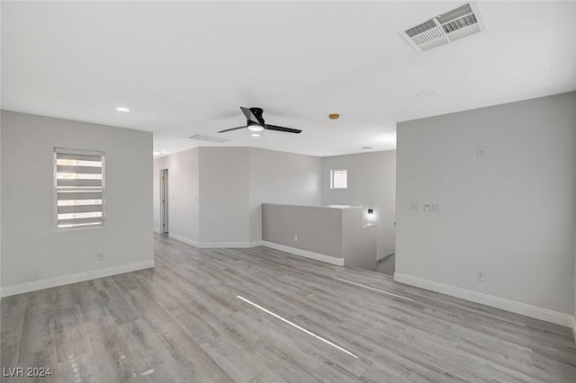 spare room with light wood-type flooring and ceiling fan