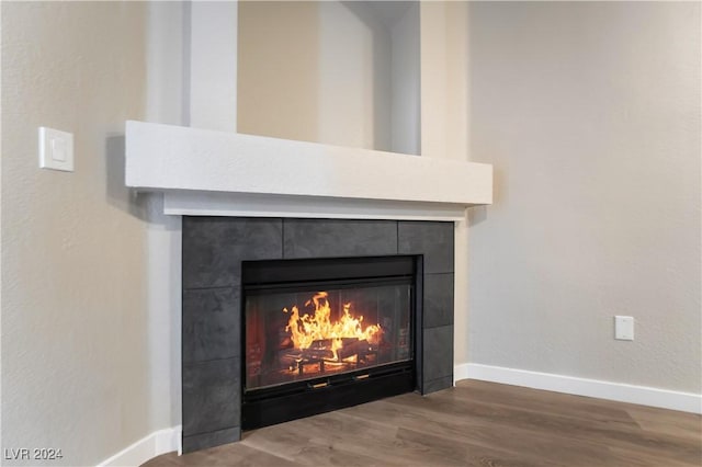 interior details featuring wood-type flooring and a fireplace