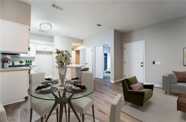 dining space featuring light wood-type flooring