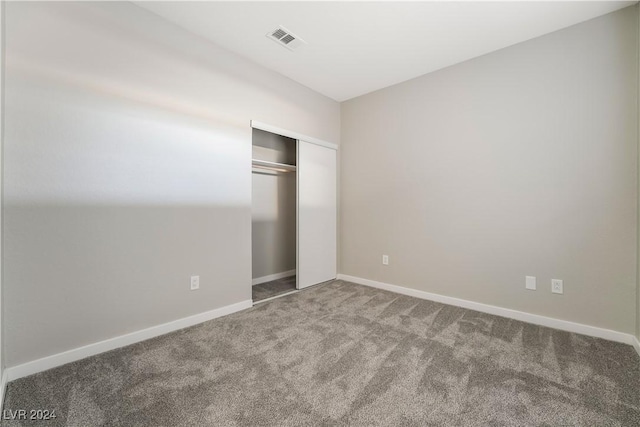 unfurnished bedroom with a closet and carpet floors