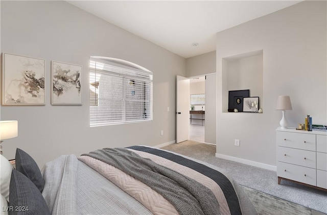 bedroom featuring light colored carpet