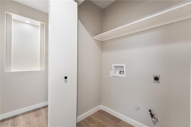 washroom with hookup for an electric dryer, washer hookup, light hardwood / wood-style floors, and gas dryer hookup