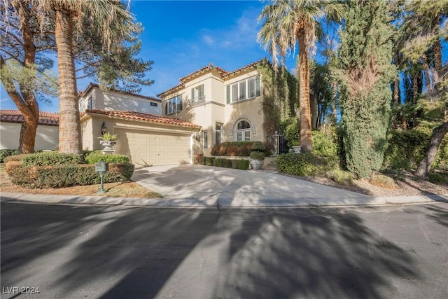 mediterranean / spanish home featuring a garage