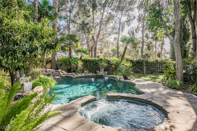 view of pool with an in ground hot tub