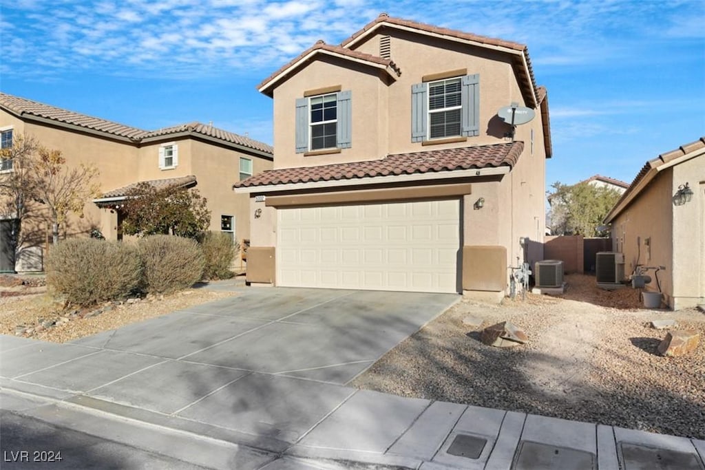 view of front of home featuring a garage and central air condition unit