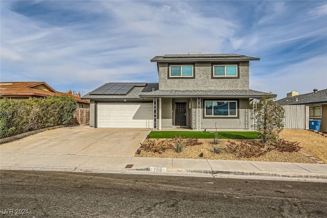 view of front of home with solar panels and a garage