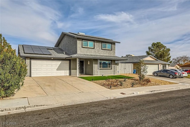 front of property featuring solar panels and a garage