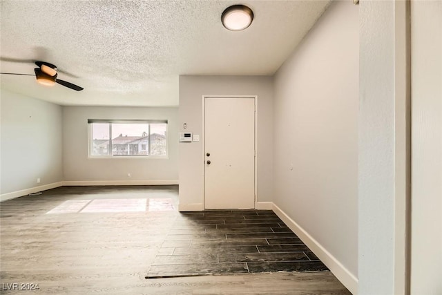 entrance foyer with ceiling fan and a textured ceiling