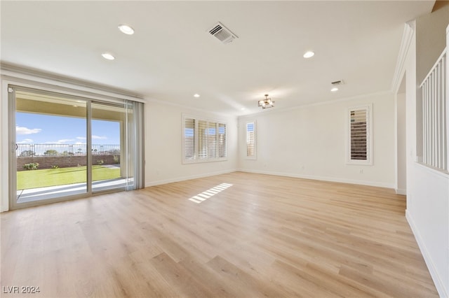 empty room featuring light hardwood / wood-style floors and crown molding