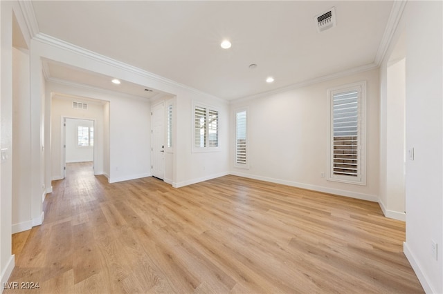 empty room featuring light hardwood / wood-style floors and ornamental molding