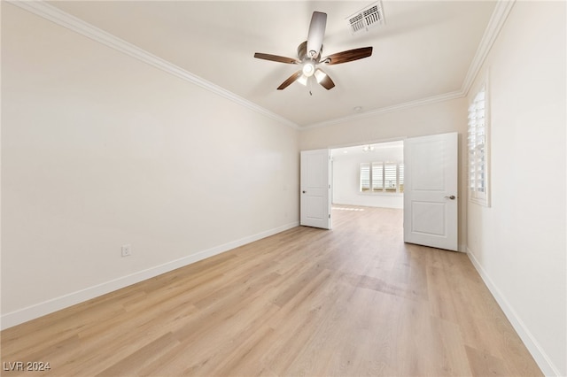 empty room featuring ceiling fan, ornamental molding, and light wood-type flooring