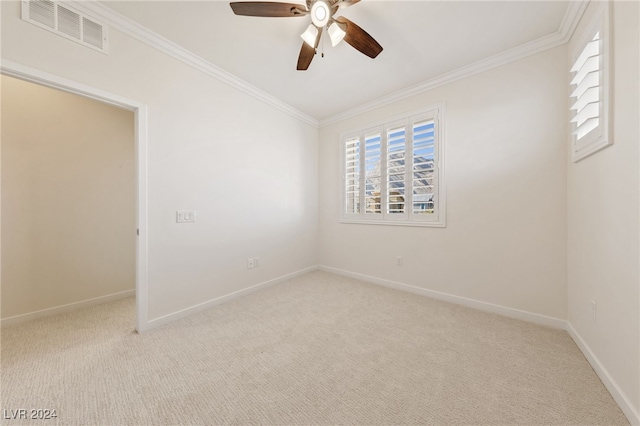 carpeted empty room featuring crown molding and ceiling fan