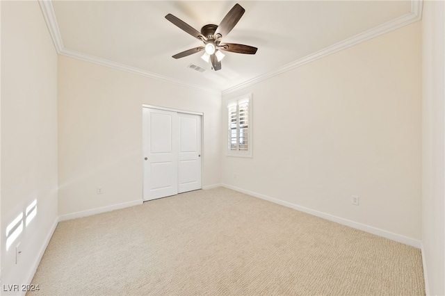 carpeted empty room with crown molding and ceiling fan