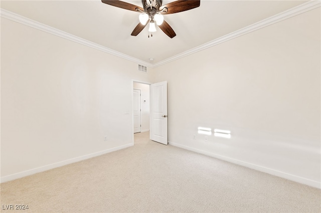 unfurnished room featuring light colored carpet, ceiling fan, and ornamental molding