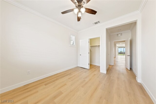 unfurnished bedroom featuring multiple windows, ceiling fan, and light hardwood / wood-style flooring