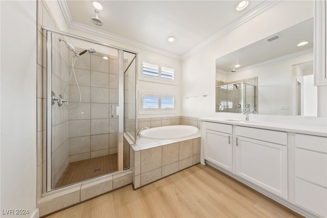 bathroom featuring hardwood / wood-style floors, ornamental molding, and plus walk in shower