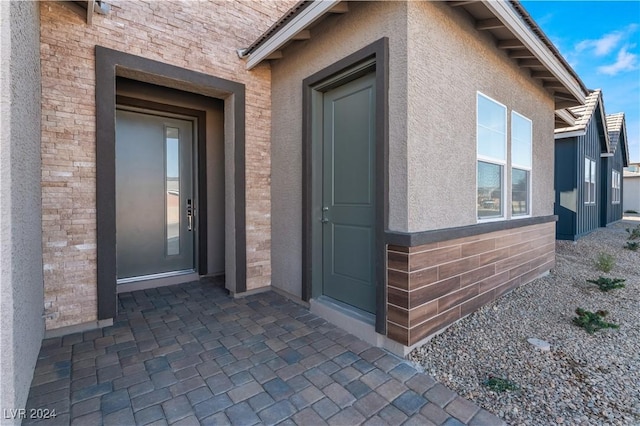 entrance to property with a patio area