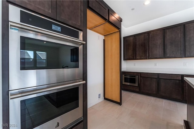 kitchen with dark brown cabinets and stainless steel double oven