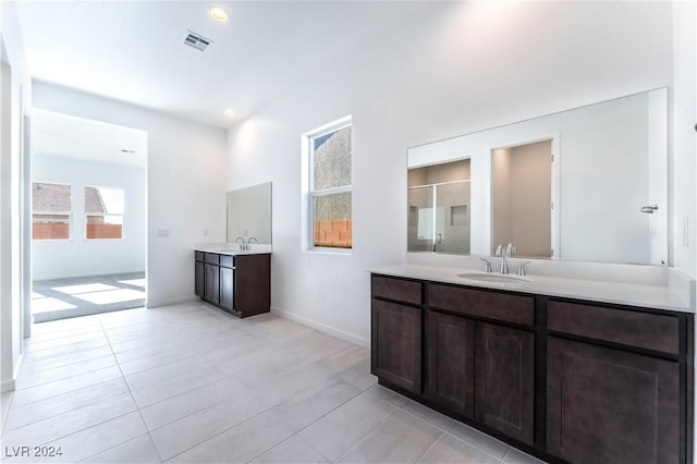 bathroom with tile patterned floors and vanity