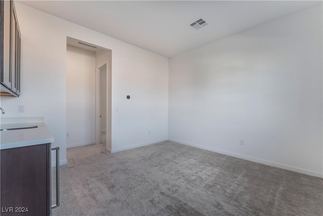 carpeted spare room with sink