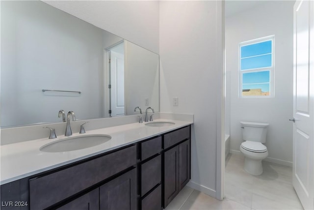 bathroom with tile patterned flooring, vanity, and toilet