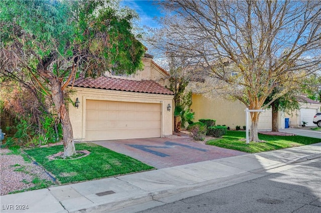 view of front of property with a front yard and a garage