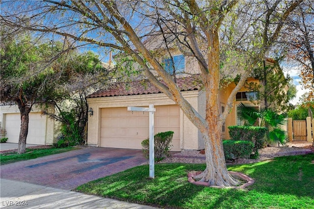 view of front of home featuring a garage and a front lawn