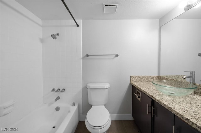 full bathroom with vanity, toilet, tiled shower / bath combo, and wood-type flooring