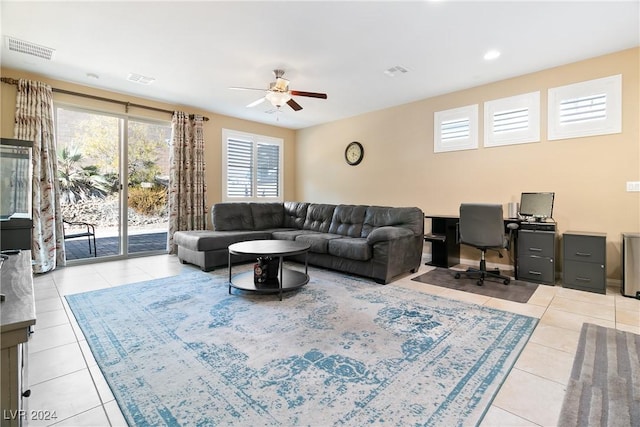 tiled living room with ceiling fan