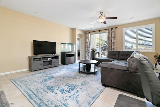 living room featuring ceiling fan and light tile patterned floors