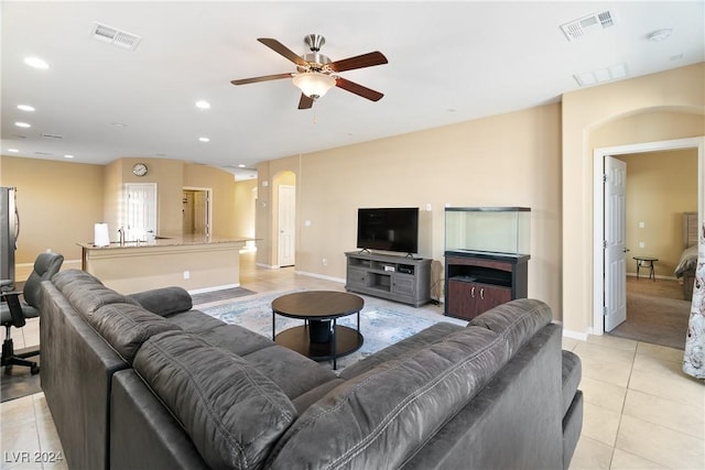 tiled living room with ceiling fan